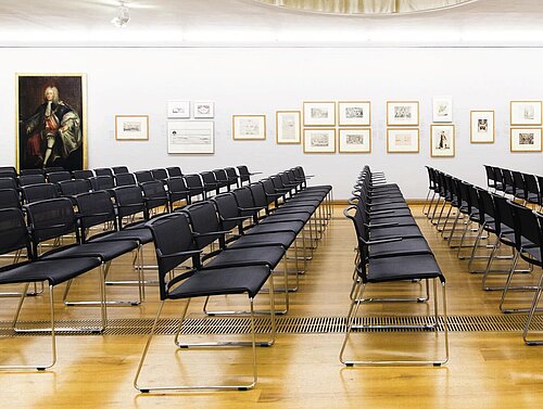 Aline chairs in gallery hall, arranged in rows for presentation