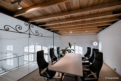 A conference room with black Graph chairs with high backrest