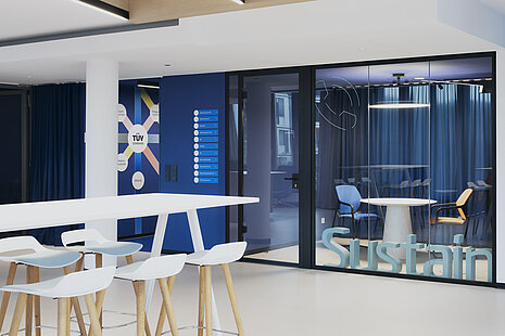 The entrance or reception area combines light-colored materials with colorful accents. Occo bar stools are visible in the foreground. Behind the glass wall in the background are Metrik cantilever chairs, which add a splash of color to the open meeting area.