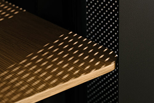 Confair Next lectern detail, close-up of perforated panel and wooden shelves