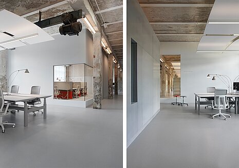 The open workspace combines industrial charm with modern office design. Several AT Mesh units in light gray are on display, blending harmoniously into the minimalist setting. The furniture’s clean lines complement the calm, functional design of the space.