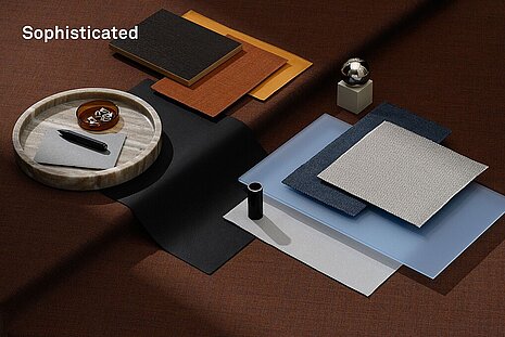 The mood board features an elegant, dark color palette of black, brown, and metallic tones, combined with high-quality fabric and material samples. The composition has a sophisticated, minimalist, and very high-quality feel—ideal for sophisticated, understated interior designs.