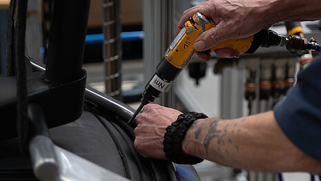 A close-up of someone installing a chair.