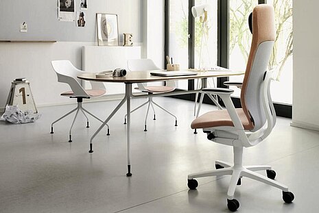 AT swivel chair in bright modern studio, collaborative meeting table scene with Occo chairs