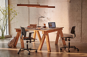 Wichair chairs at wooden worktable, studio workspace scene