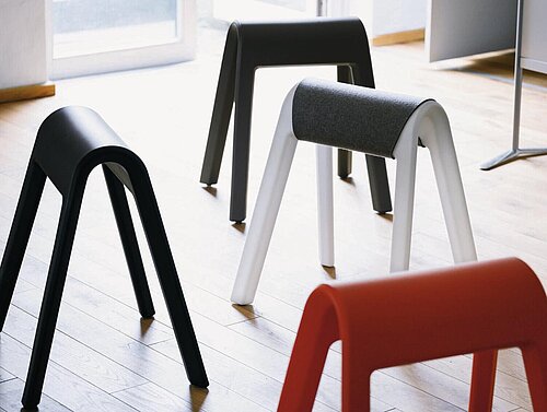 Sitzbock stools in open space, multiple colors arranged
