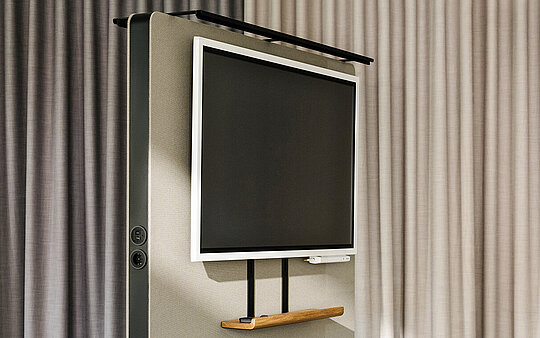 Confair Next mediawall in office environment with mounted screen and shelves