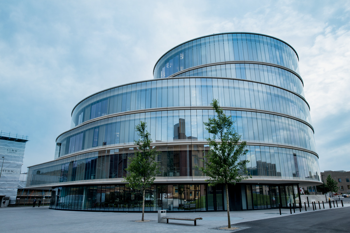The building by architects Herzog & de Meuron consists of a series of four discs stacked on top of one another and shifted slightly on each floor and a rectangular section, all of which are connected with one another by a spiral staircase in the middle.